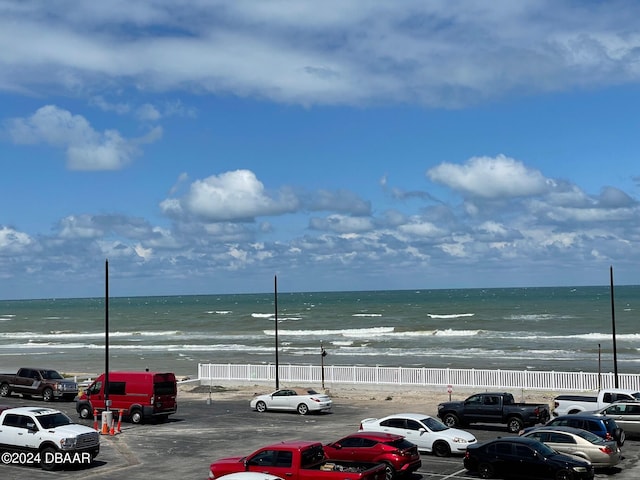 view of parking / parking lot featuring a water view