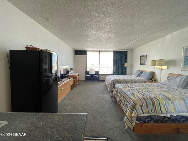 carpeted bedroom featuring a textured ceiling and black fridge