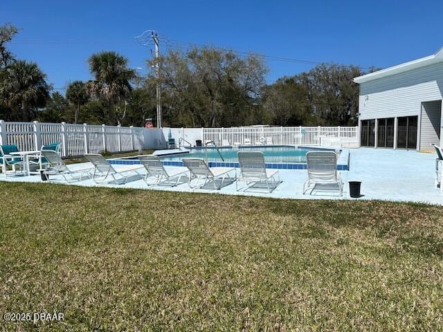 community pool featuring a yard, a patio, and fence