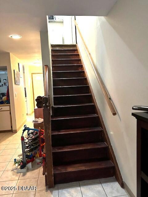 stairs with tile patterned flooring and baseboards