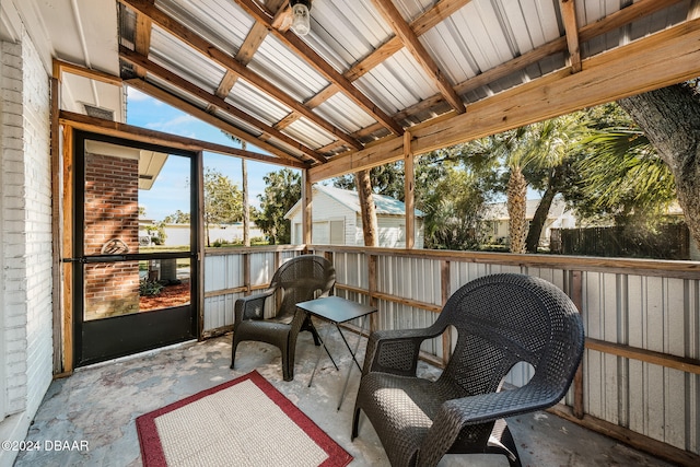 sunroom / solarium featuring lofted ceiling