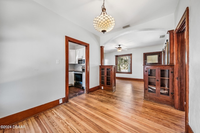 unfurnished dining area featuring light wood-type flooring and ceiling fan