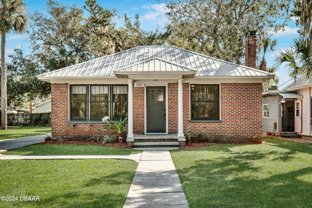 bungalow-style home featuring a front yard