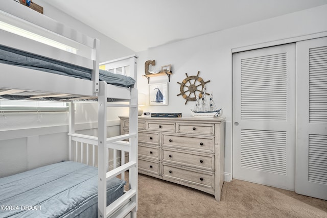 carpeted bedroom with a closet