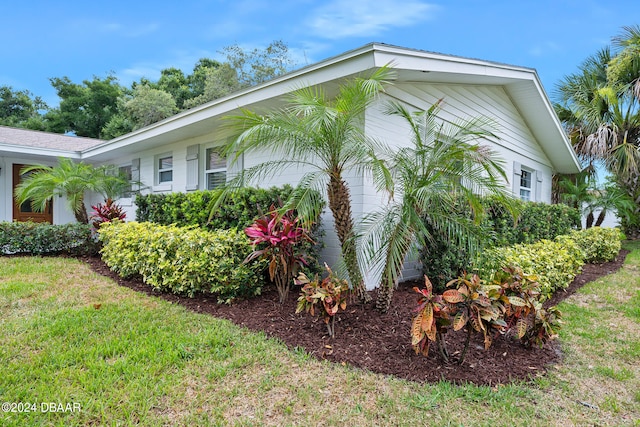 view of side of home featuring a lawn