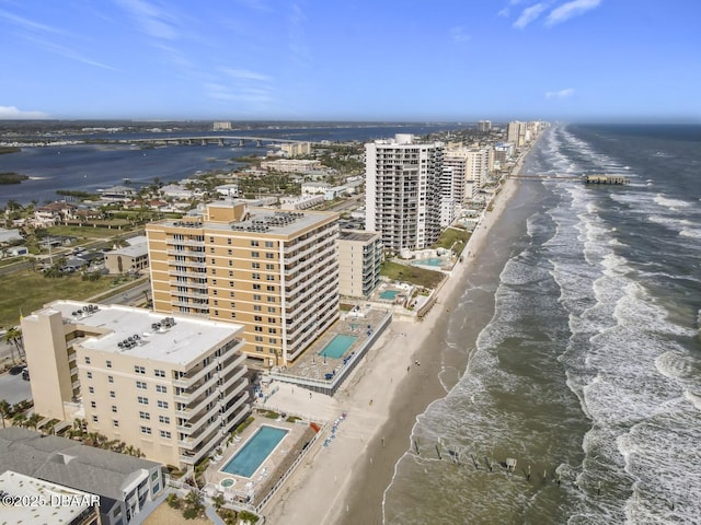 aerial view featuring a water view, a city view, and a view of the beach