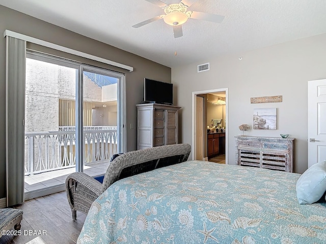 bedroom with a ceiling fan, wood finished floors, visible vents, a textured ceiling, and access to outside