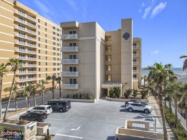 view of building exterior featuring uncovered parking