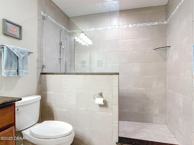 full bathroom with a tile shower, toilet, and vanity