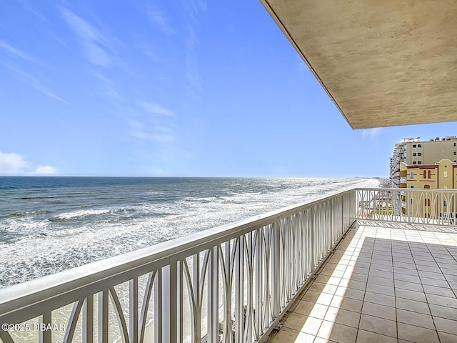 balcony featuring a water view and a view of the beach