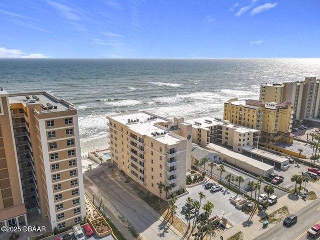 birds eye view of property with a water view and a city view