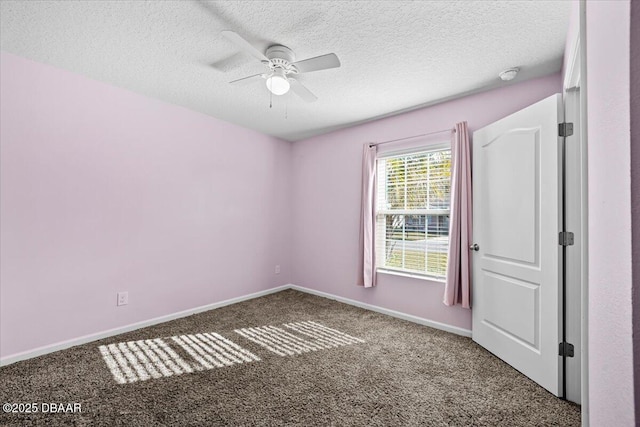 carpeted spare room with ceiling fan and a textured ceiling