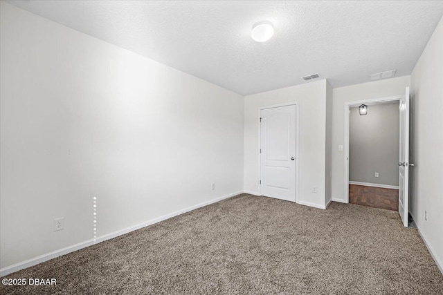 unfurnished bedroom featuring carpet flooring and a textured ceiling