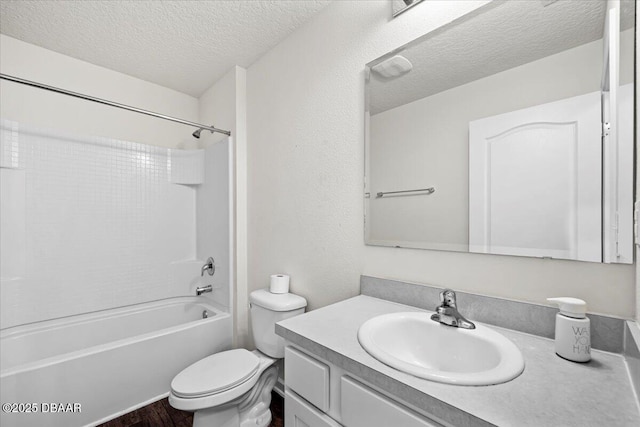 full bathroom featuring hardwood / wood-style floors, shower / bath combination, vanity, toilet, and a textured ceiling