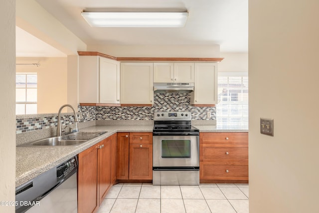 kitchen with appliances with stainless steel finishes, sink, backsplash, plenty of natural light, and light tile patterned flooring