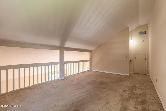 bonus room with carpet flooring and vaulted ceiling