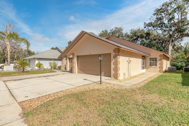 view of front of home featuring a garage, central AC, and a front lawn