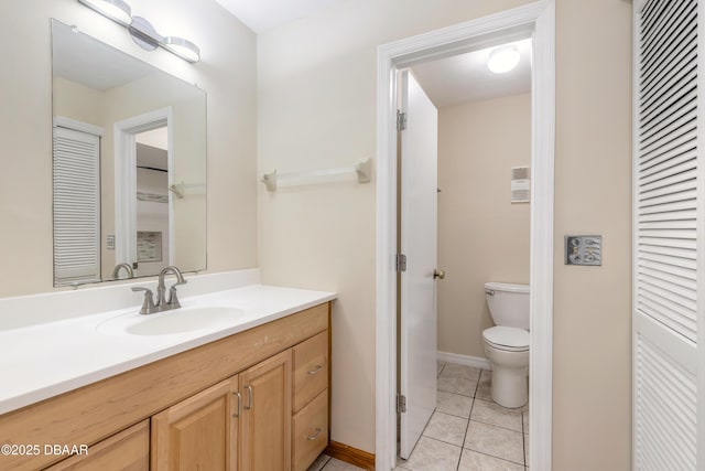 bathroom with vanity, toilet, and tile patterned flooring