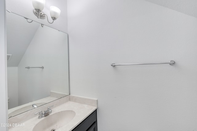 bathroom featuring vanity and vaulted ceiling