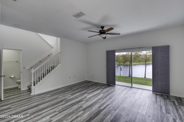 123 Langston Dr, Daytona Beach, FL 32124 - unfurnished living room with wood finished floors, stairway, a water view, ceiling fan, and baseboards