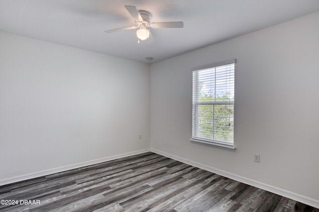 spare room featuring dark wood-type flooring and ceiling fan