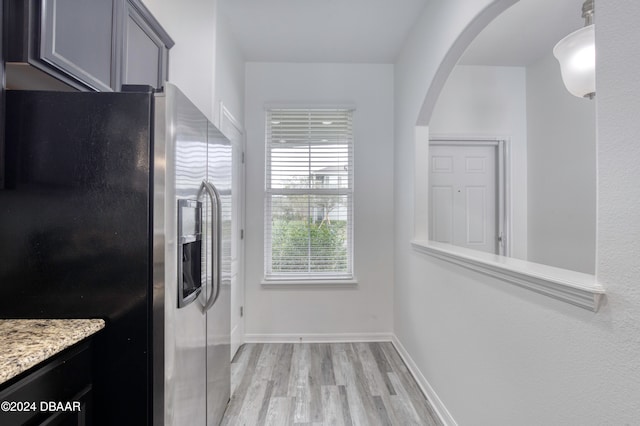 kitchen with stainless steel refrigerator with ice dispenser, light hardwood / wood-style flooring, and gray cabinets