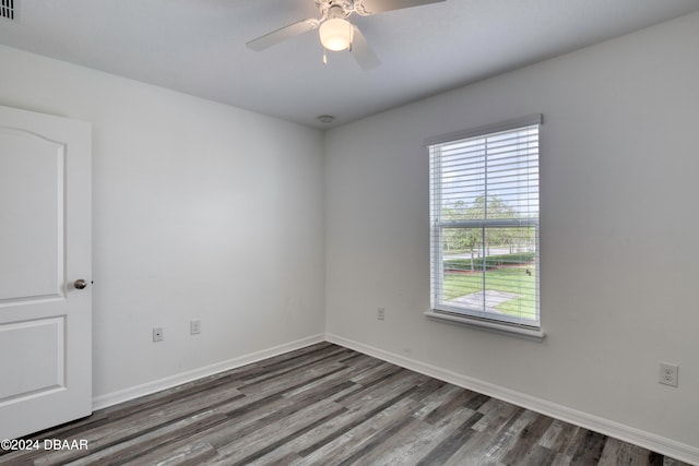 empty room featuring dark hardwood / wood-style flooring and ceiling fan