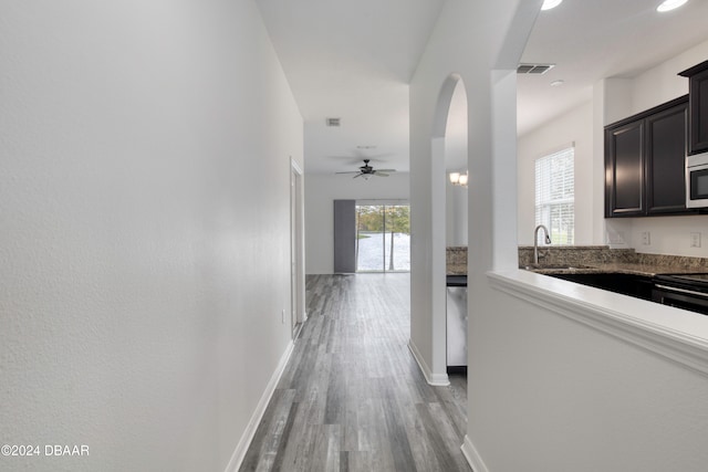 hall featuring light wood-type flooring and sink