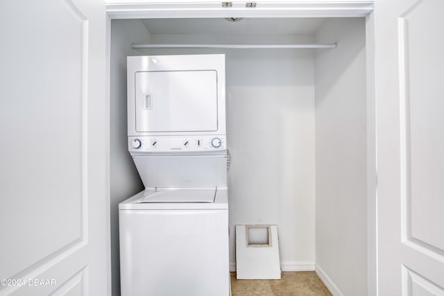 clothes washing area with stacked washer and dryer