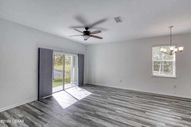 unfurnished room featuring hardwood / wood-style floors and ceiling fan with notable chandelier