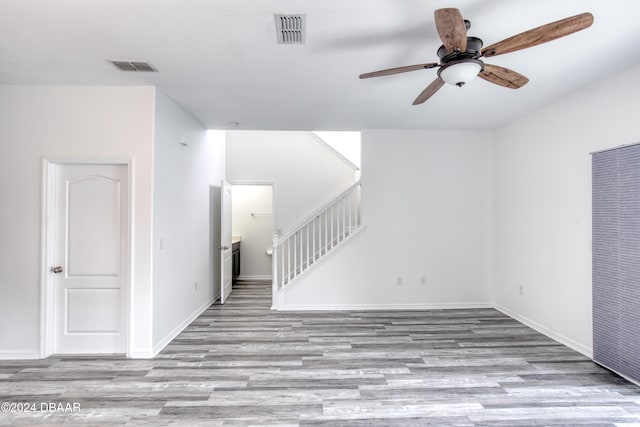 empty room featuring ceiling fan and light hardwood / wood-style flooring