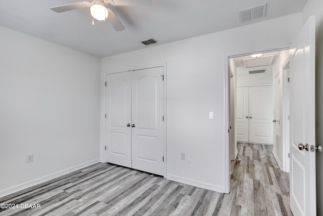 unfurnished bedroom with a closet, light wood-type flooring, and ceiling fan