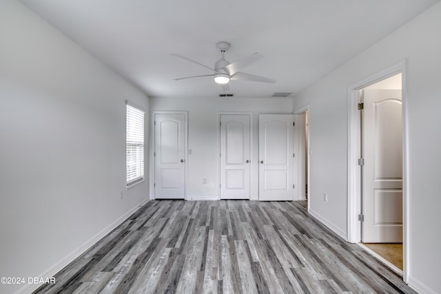 unfurnished bedroom featuring ceiling fan and wood-type flooring