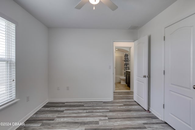 unfurnished bedroom featuring light wood-type flooring and ceiling fan