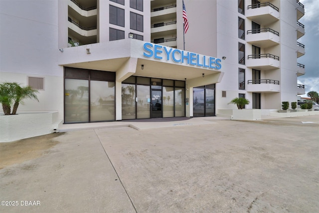 entrance to property featuring stucco siding