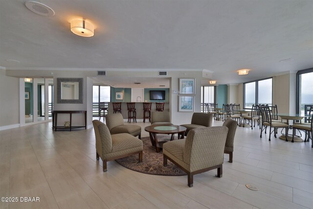 3855 S Atlantic Ave S Unit 1405, Daytona Beach, FL 32118 - living area featuring plenty of natural light, ornamental molding, and visible vents