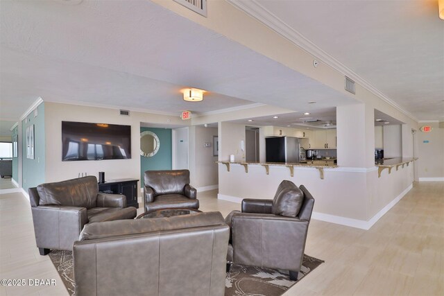 3855 S Atlantic Ave S Unit 1405, Daytona Beach, FL 32118 - living area featuring crown molding, baseboards, and light wood finished floors