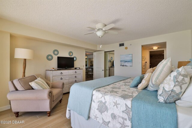 3855 S Atlantic Ave S Unit 1405, Daytona Beach, FL 32118 - bedroom featuring visible vents, light wood-style floors, ensuite bathroom, a textured ceiling, and a ceiling fan