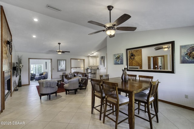 29 Concord Dr, Ormond Beach, FL 32176 - dining space featuring a ceiling fan, light tile patterned floors, lofted ceiling, recessed lighting, and a glass covered fireplace