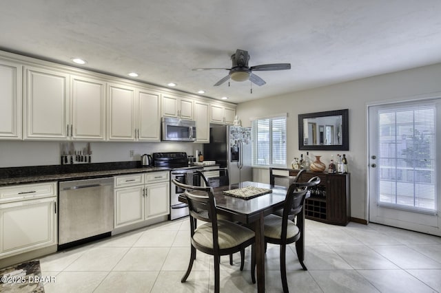 29 Concord Dr, Ormond Beach, FL 32176 - kitchen with appliances with stainless steel finishes, a ceiling fan, recessed lighting, light tile patterned floors, and dark stone countertops