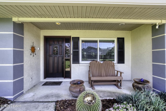 29 Concord Dr, Ormond Beach, FL 32176 - property entrance featuring stucco siding and a porch