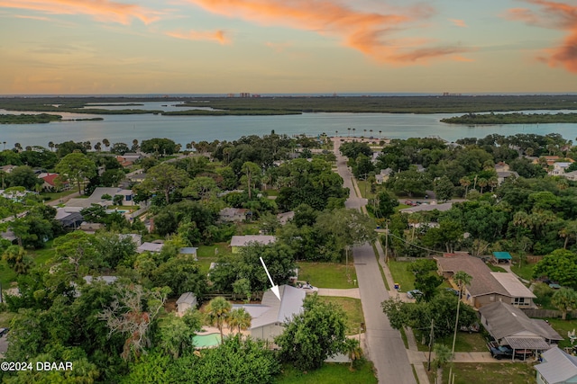 aerial view at dusk with a water view