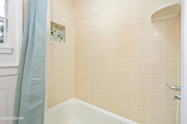 bathroom featuring shower / bathtub combination with curtain