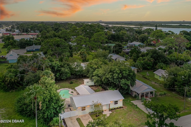 aerial view at dusk with a water view