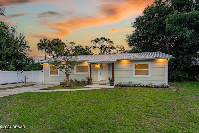 ranch-style home with a lawn