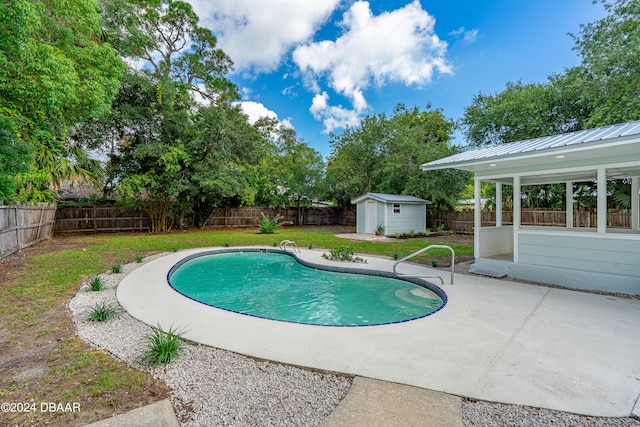 view of pool featuring a patio area and a storage unit