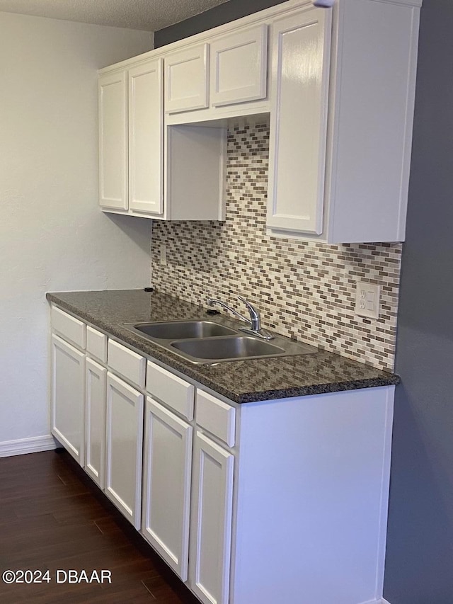 kitchen featuring white cabinets, sink, and dark hardwood / wood-style flooring