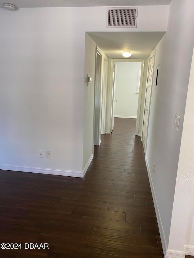 hall with dark hardwood / wood-style flooring