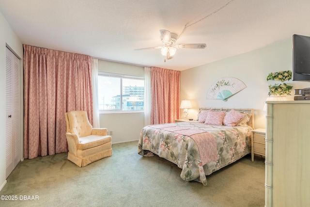 carpeted bedroom featuring ceiling fan and a closet