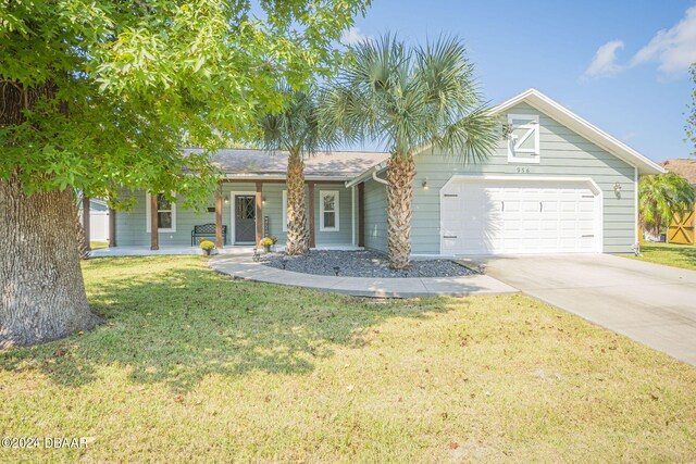 ranch-style home with a garage and a front lawn